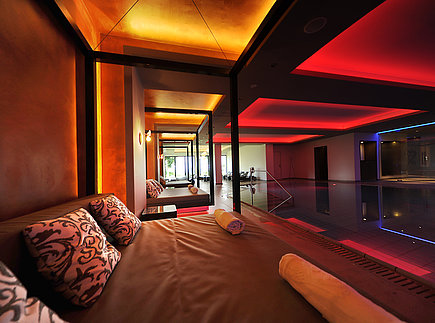Comfortable daybeds by the indoor pool